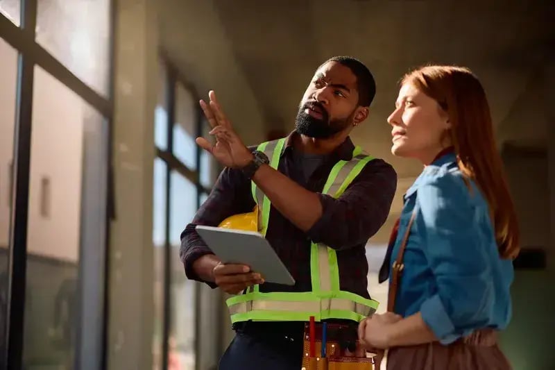 Workers using a tablet in a warehouse
